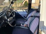 a white van with a blue seat cover and a steering wheel