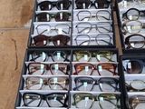 many pairs of glasses sitting in a box on a table