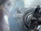 a close up of a metal object with a bird on it