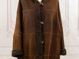 a woman ' s brown shear coat on a mannequin mannequin stand