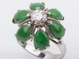 an image of a ring with green and white stones and a diamond