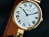 a person holding a gold wrist watch with roman numerals