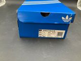 a blue box with a white stripe on it sitting on the floor
