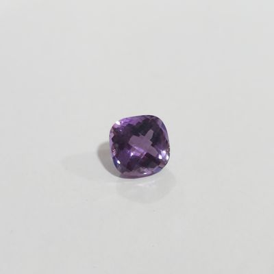 a cushion cut amethorate gems on a white surface