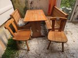 deux chaises en bois et une table sur une terrasse carrelée