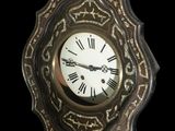 a clock that is hanging on the wall in the dark
