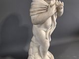 marble statue of a boy with a bow on a pedestal