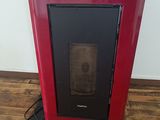 a picture of a red stove in the corner of a room