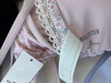 a pink bra with a tag on it next to other bras