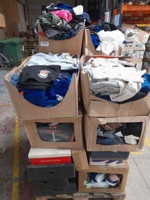 several boxes of clothing are stacked on top of each other in a warehouse