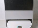 an image of a white robot sitting on top of a table