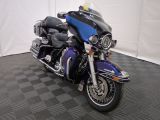 a blue and black motorcycle parked on a black and white checkered floor