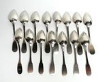 six spoons and a spoon rest in a row on a white surface
