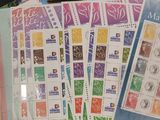 a pile of stamps and envelopes sitting on a table