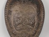 an old metal shield with a design on it
