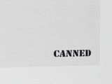 a black and white photo of a sign on a white wall