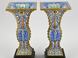 pair of blue and gold vases with oriental designs on them