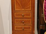 an image of a wooden chest of drawers with a guitar on top of it