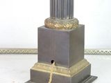 a lamp that is sitting on a table with a chain around it