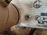 a close up of a silver radio on a table