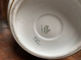 a close up of a white bowl on a wooden table