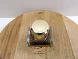 a bottle of perfume sitting on a wooden table