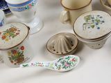 many different types of cups and spoons on the table