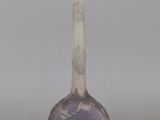 a glass vase with a purple flower design on it