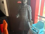a statue of a man with a walker in a room
