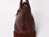 a close up of a brown leather handbag on a white background