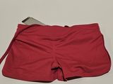 red shorts with a cell phone in the pocket on a white surface