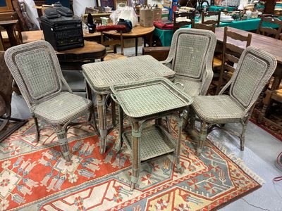 several chairs and a table in a room with a rug on the floor