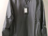 the jacket is hanging on a hanger on the wall