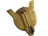 a gold bird shaped pin with a metal handle