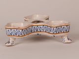 a small blue and white bowl on a stand