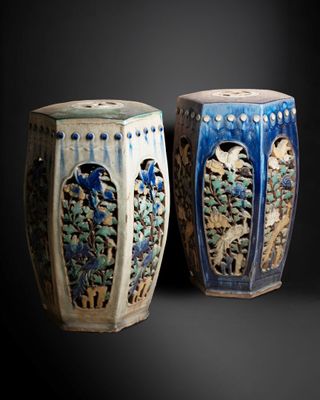 two vases that are sitting side by side on a black background