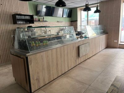 a picture of a restaurant with a counter and a television
