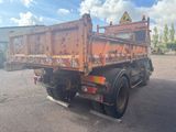 an image of a rusted dump truck parked in a parking lot