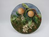 a decorative plate with flowers and fruit on it
