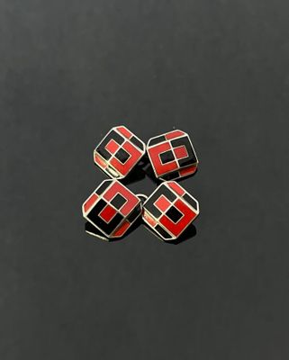 four red and black squares on a black surface