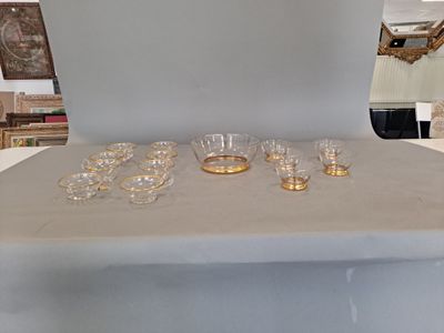 a table with a bunch of glasses and a bowl on it