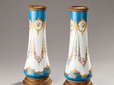 pair of blue and white vases with gold trimmings on them