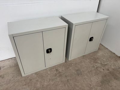 pair of white metal storage cabinets with black handles