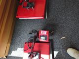 two red pedals sitting on the floor next to a pair of shoes