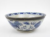 a blue and white bowl sitting on a white surface