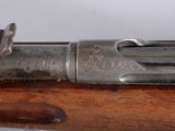 an old gun with a wooden handle on a white background