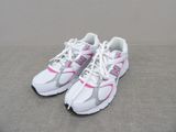 pair of white and pink running shoes on a gray surface