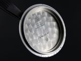 a metal pan with a lid on a black surface