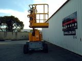 a yellow scissor parked in front of a building