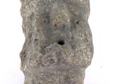 a rock with a hole in it on a white surface